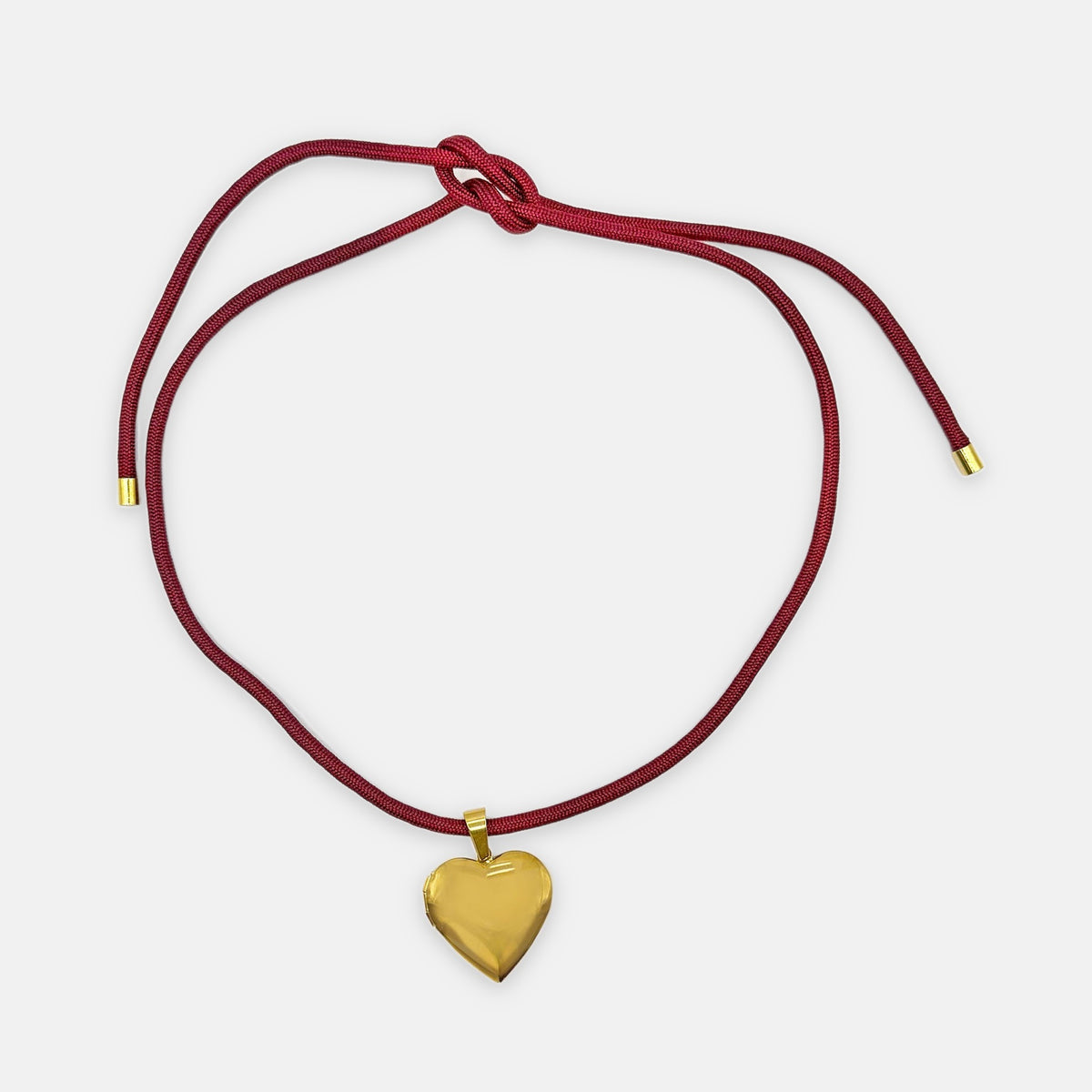 Isla Sol Burgundy Love Necklace, wine-red cord with a gold heart locket pendant