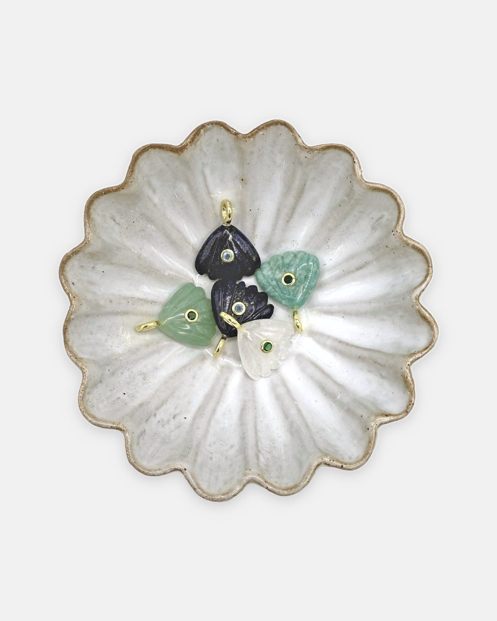 Coquille charms in amazonite, aventurine, lapis lazuli, and crystal quartz in a scalloped ceramic dish – Isla Sol