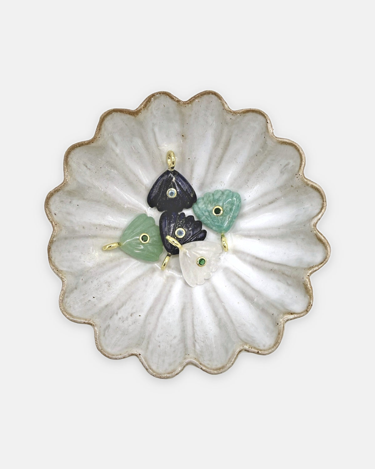 Coquille charms in amazonite, aventurine, lapis lazuli, and crystal quartz in a scalloped ceramic dish – Isla Sol