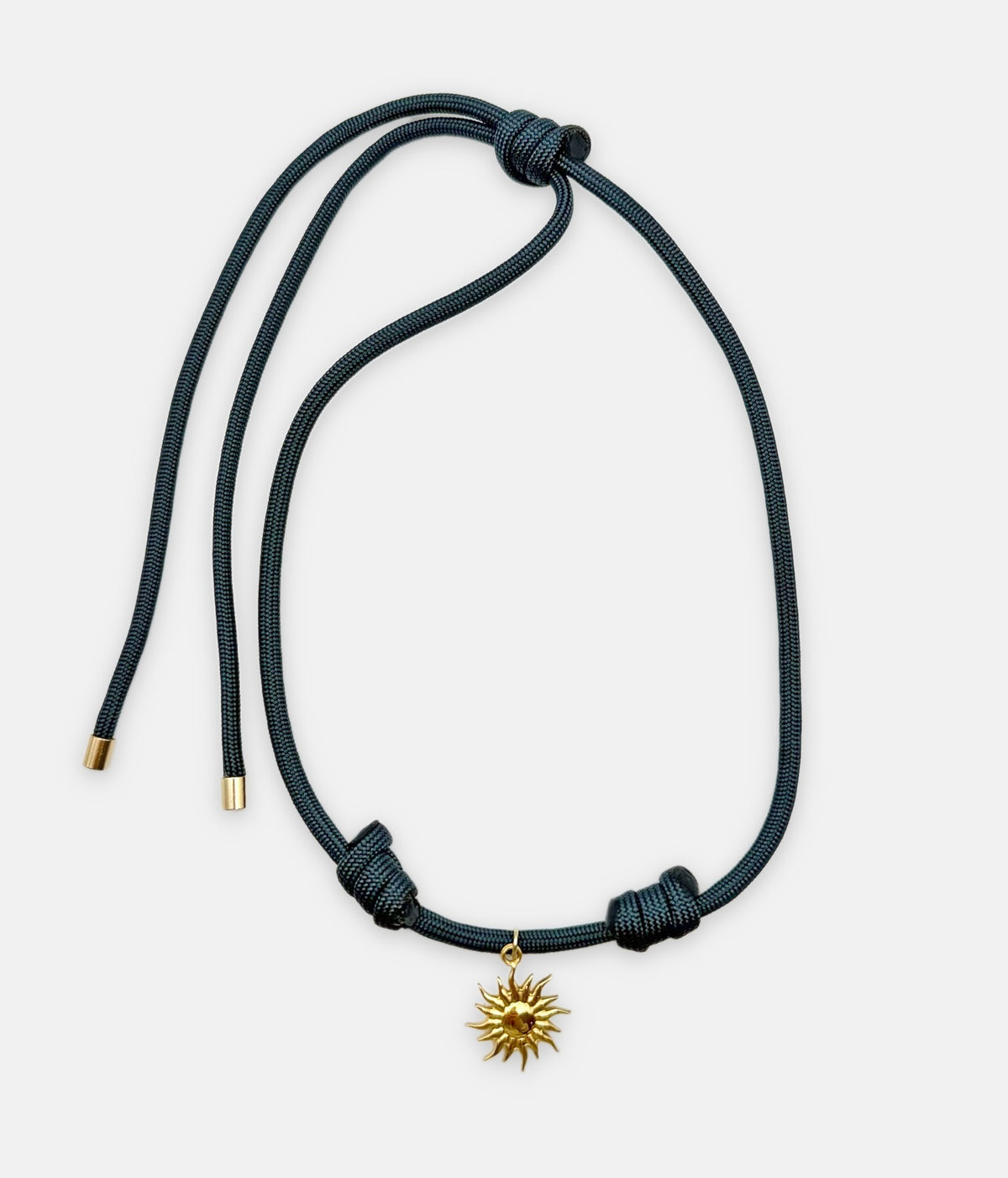 Isla Sol Midnight Solstice Necklace, deep teal paracord with a gold sun charm and sliding knots